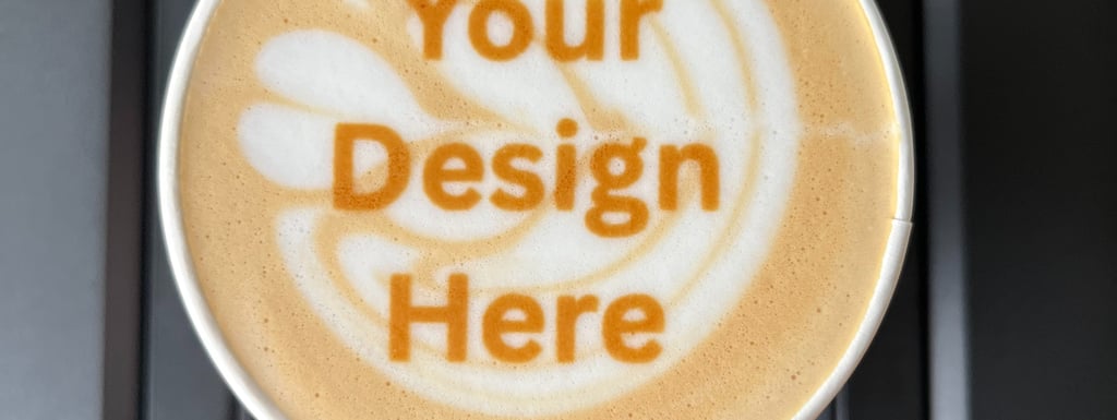 A latte with "your design here" on top of the latte art