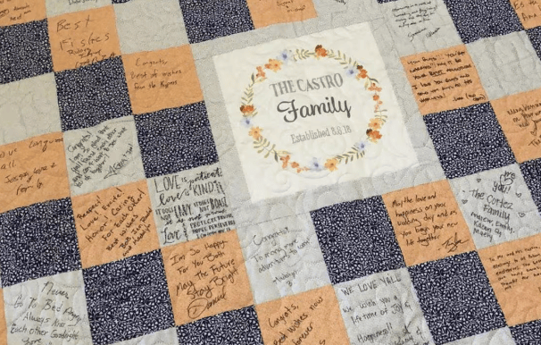Wedding guest book quilt signing station with fabric squares and fabric pens