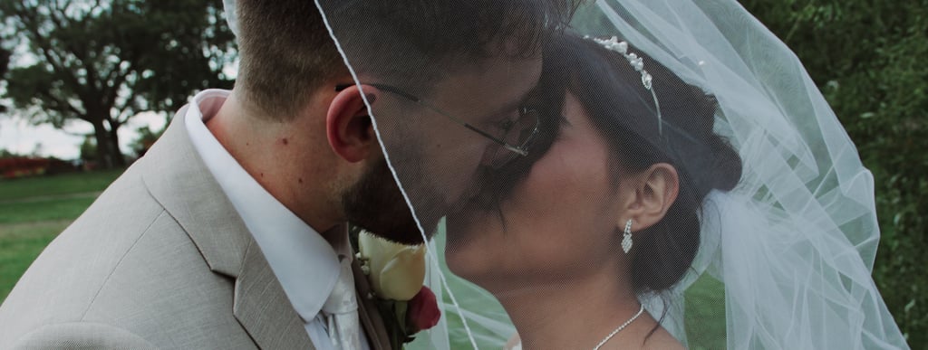 Candid moment of bride and groom kissing during Toronto wedding photographed authentically