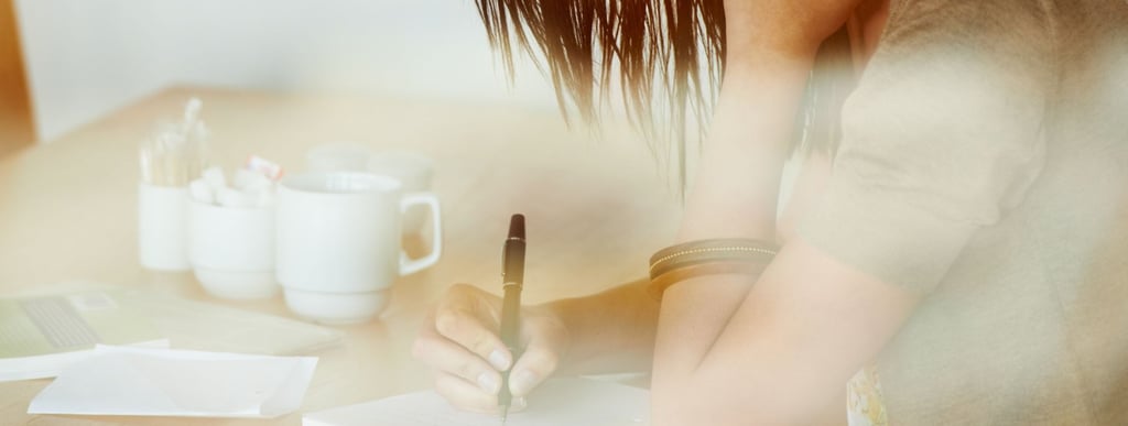  Woman journaling in a cozy space, practicing self-care.