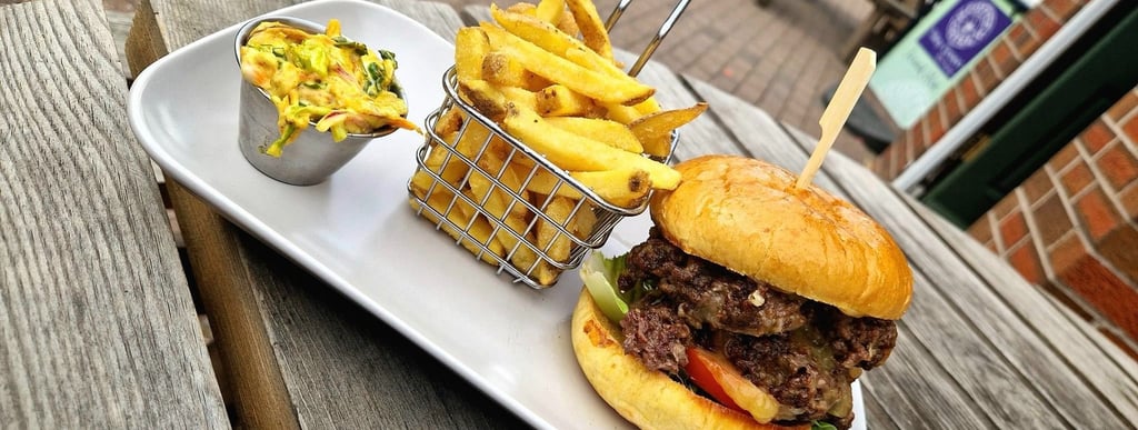 a tray of food on a table with a burger, slaw and fries