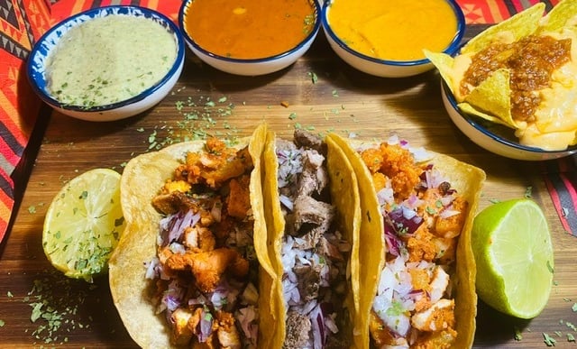 a table with a variety of tasty tasty tacos