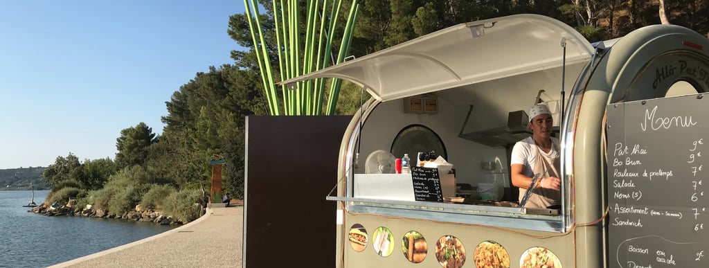 a food truck with a man standing in front of it
