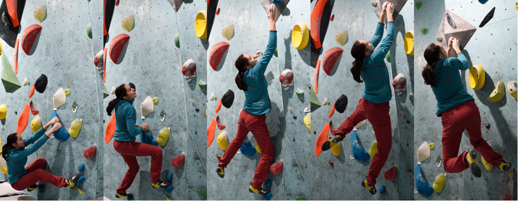 a woman doing dynamic movement on a climbing wall