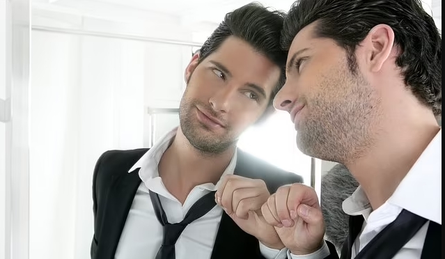 conceited guy staring at himself in mirror