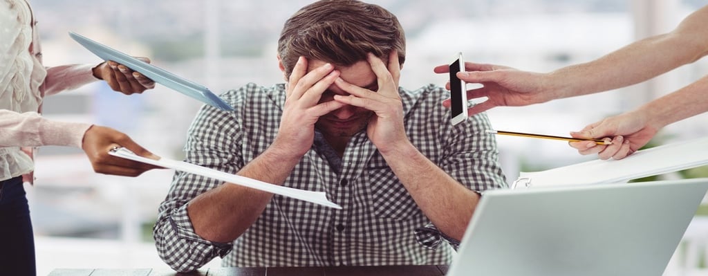 A stressed man sitting in front of laptop