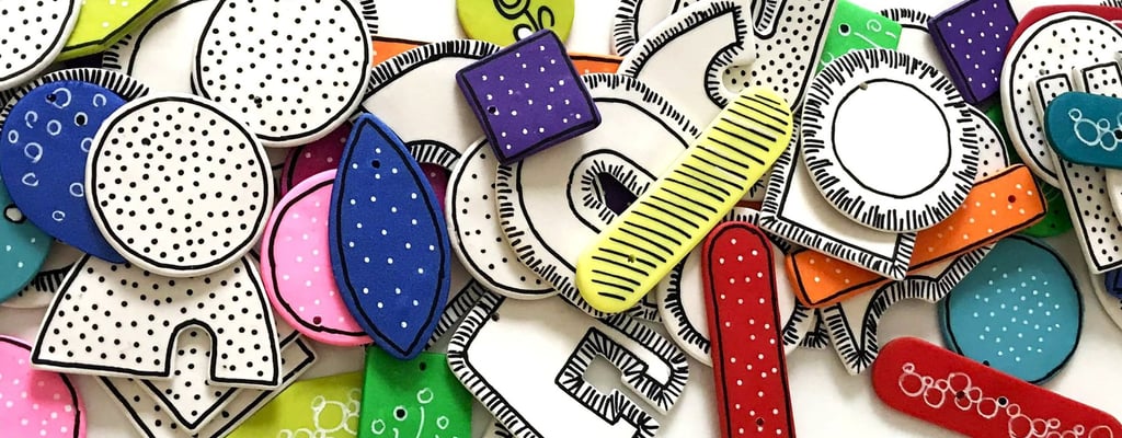 a bunch of different colored earring components