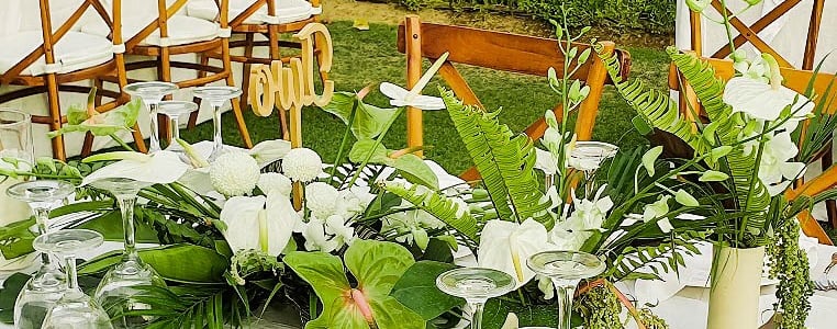 a table with a table setting with white tablecloth and white tablecloth