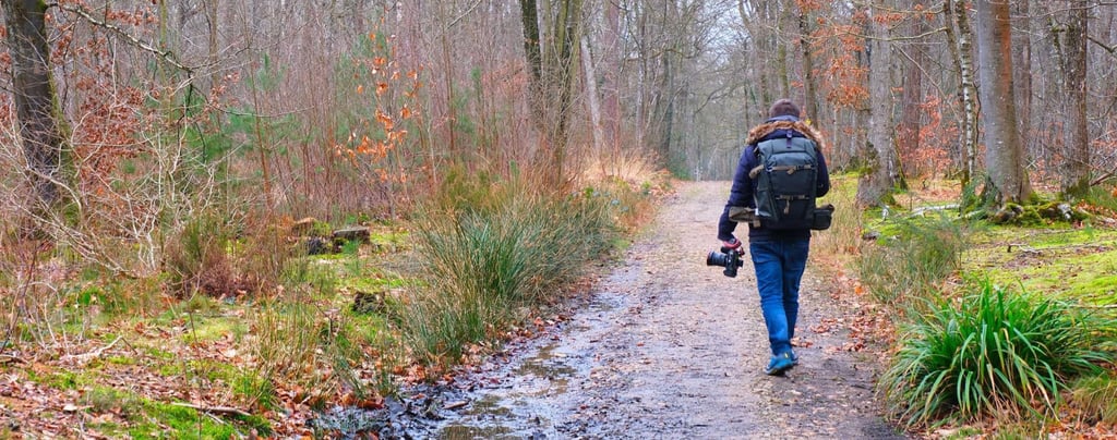 a man walking down a path with a backpack on his back