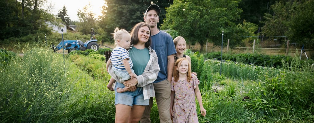Family gardening together on sustainable homestead in Australia