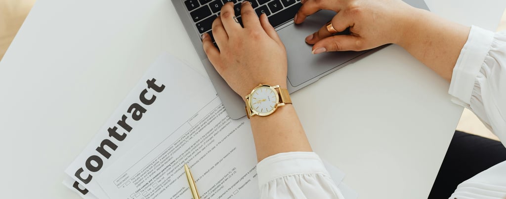 a woman sitting at a desk with a laptop and a watch