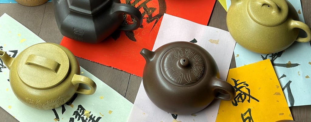 Several teapots arranged on various colored papers, each inscribed with different text