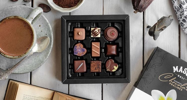 a box of chocolates and a cup of coffee