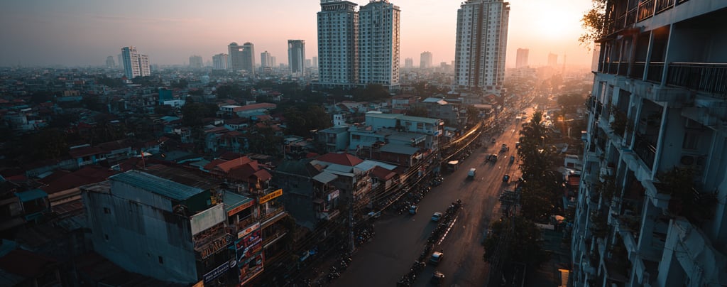Wide view of the Phnom Penh skyline showing new high rise apartment buildings and busy urban streets