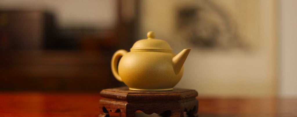 Light yellow teapot placed on a wooden stand