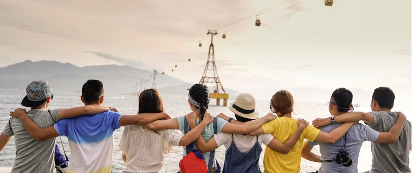 Group of teenager friends with arms over their shoulders