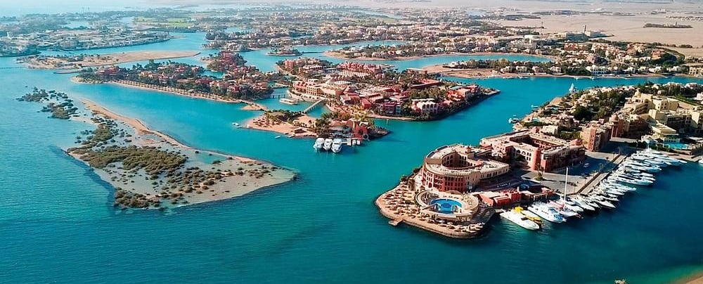 Aerial view of El Gouna Red Sea resort with luxury villas, blue lagoons, and a marina in Egypt.