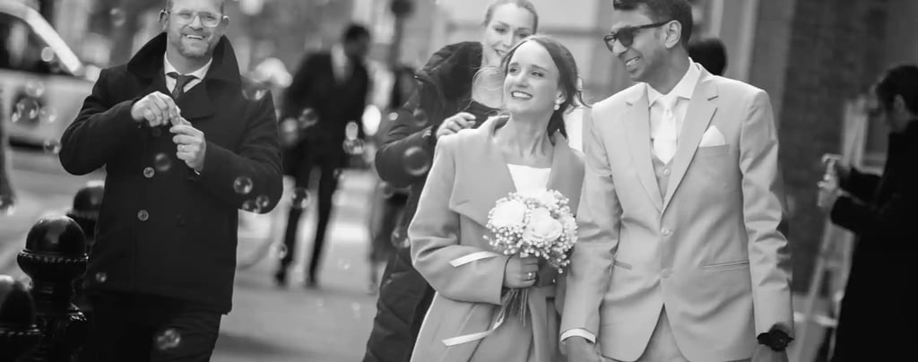 Sarah and Shreya walking about the streets of Chelsea after their wedding ceremony