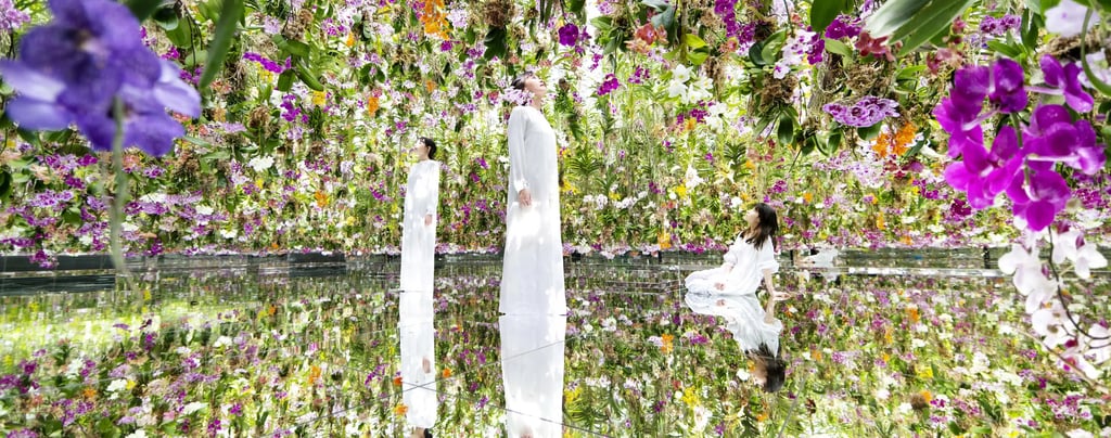 a woman sitting in the mirror room with flowers