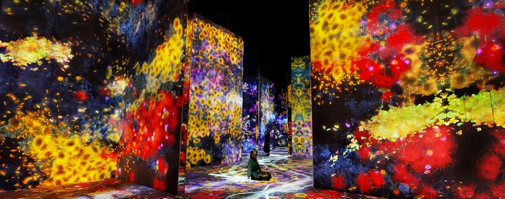 a person standing in front of a large screen with flower lights
