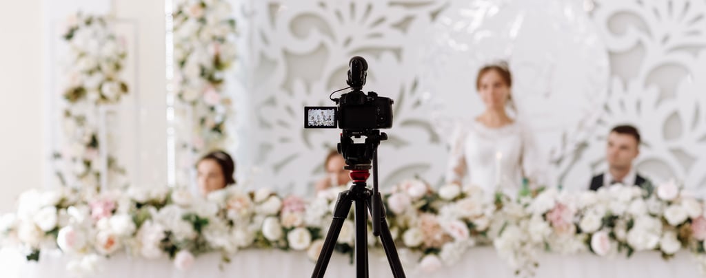 Glasgow wedding videographer filming bride and groom at a floral top table—cinematic reception cover
