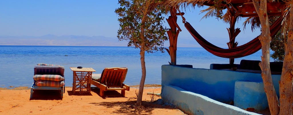 beachview with chaise lounge and bungalow in front of the sea Bedouin star Egypt