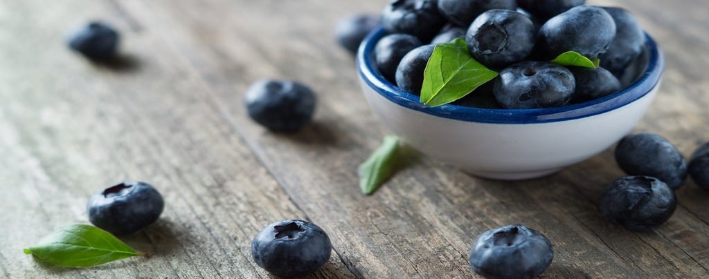 Blueberries in a cup and on the table