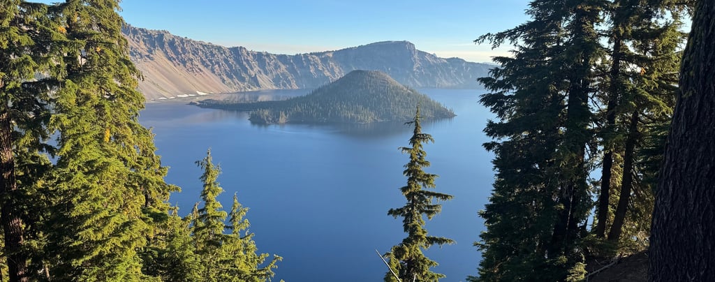 A vibrant aerial shot of Crater Lake's sapphire waters encircled by snow-dusted cliffs, captu