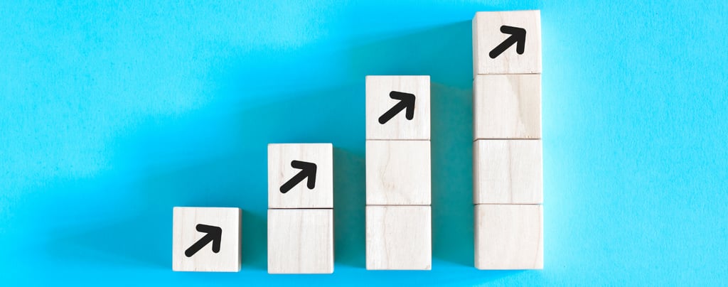 stacks of blocks getting progressively taller, representing growth