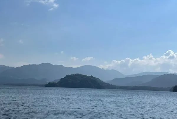 a boat is sailing on Lago de Yojoa Honduras