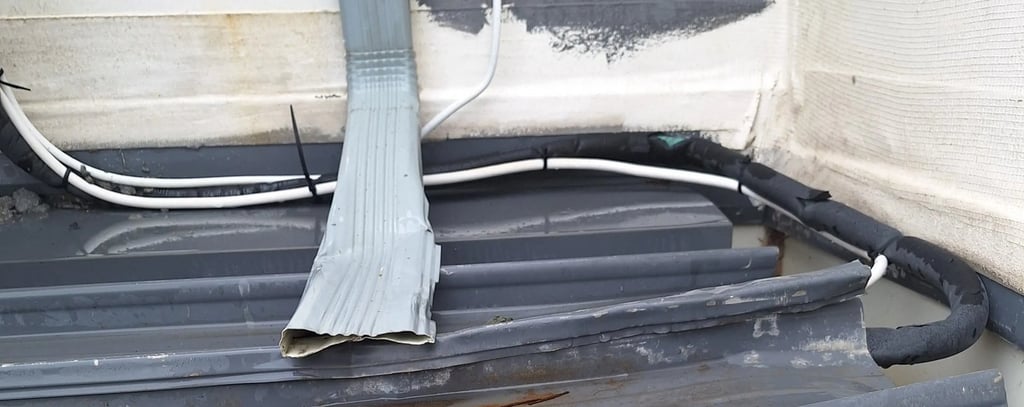 Overflowing roof gutter with poor drainage