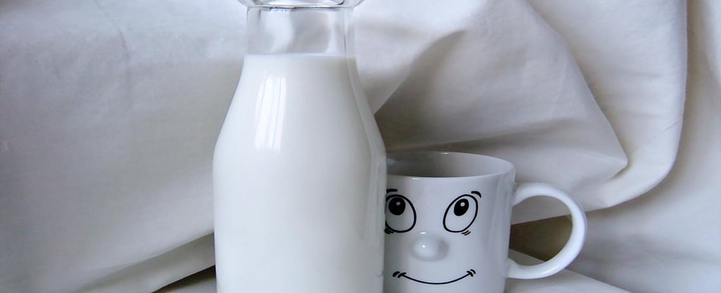 Milk in a glass bottle and a Cup