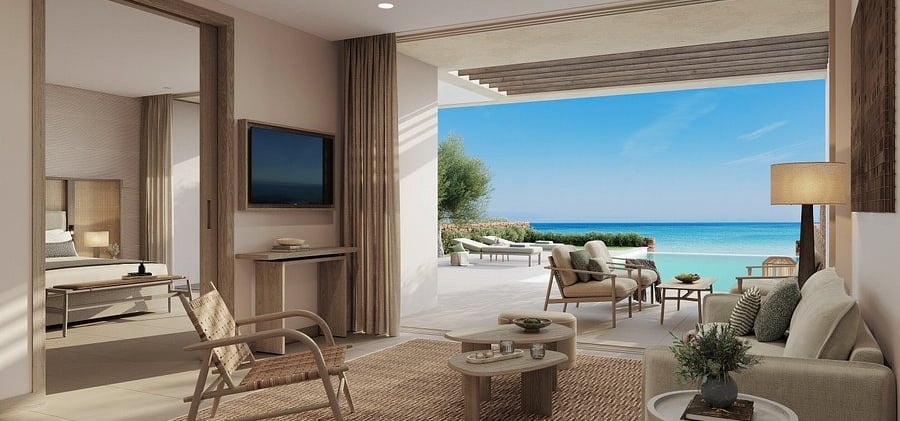 Luxury beachfront hotel suite with modern interior design, private terrace, and ocean views.
