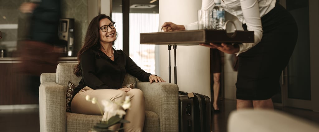 Woman being served water at airport lounge