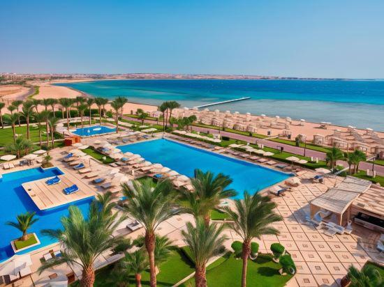 Premier Le Reve Hotel and Spa with blue swimming pools, palm trees overlooking the Red Sea coast.