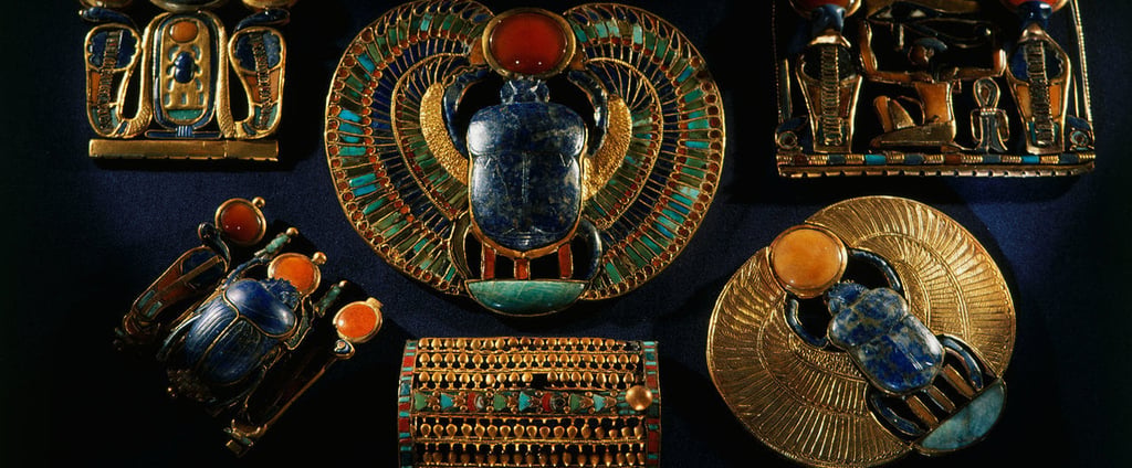 Ancient Egyptian gold jewelry featuring lapis lazuli scarab beetles and carnelian stones.