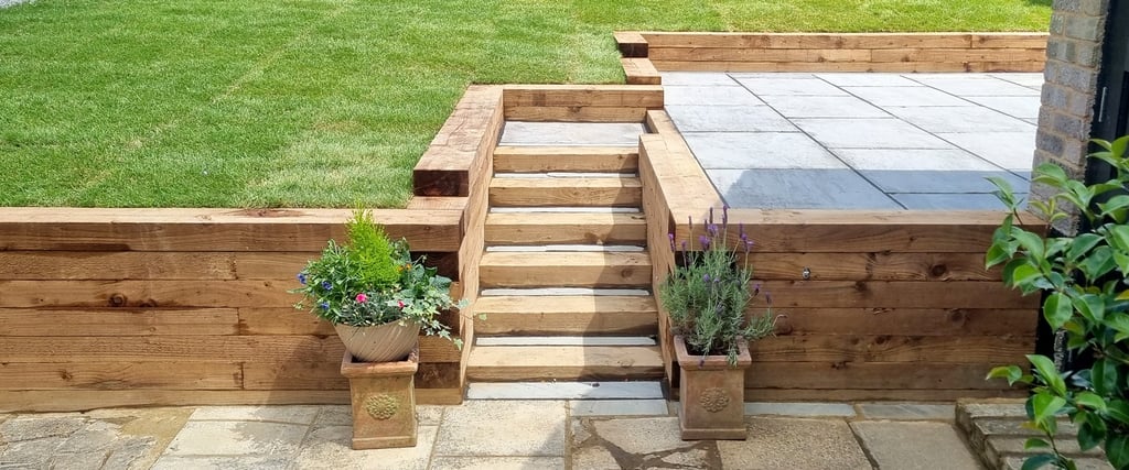 Sleeper Retaining Walls, Planters & Steps With Grey Sandstone Patio & Lawn