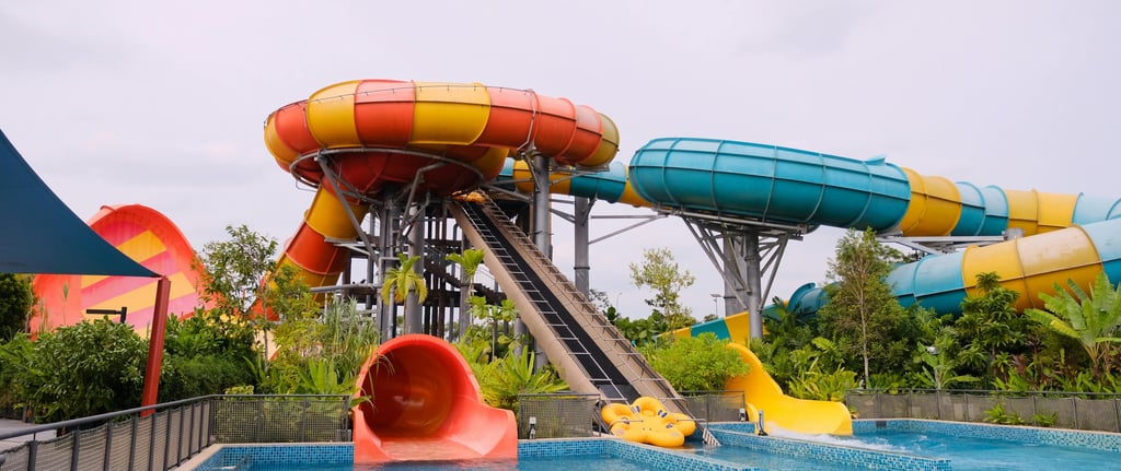 Red and yellow waterslide with a small pool below