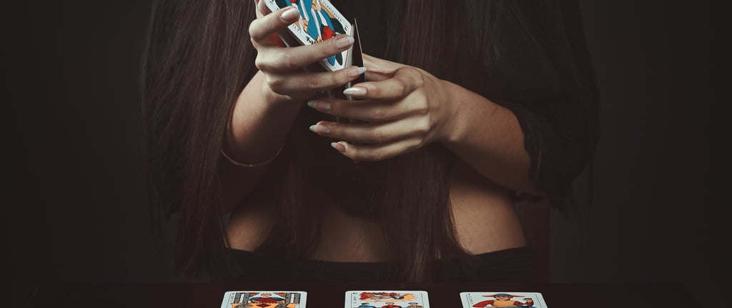 woman holding tarot cards during a tarot reading