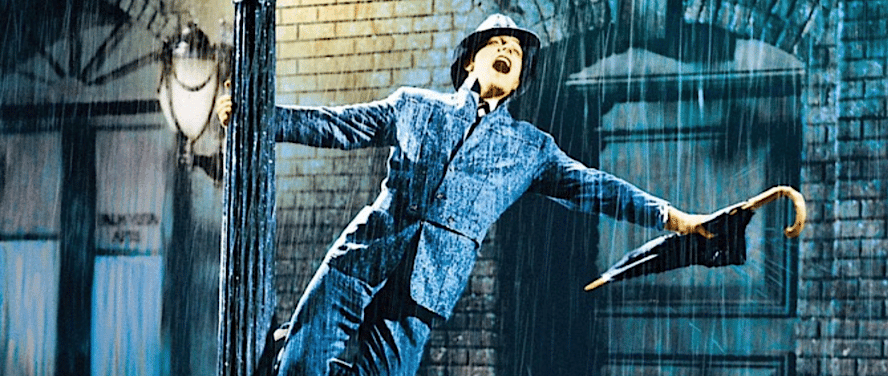 Gene Kelly sings on a lamppost with umbrella during ‘Singin’ in the Rain’ (1952)
