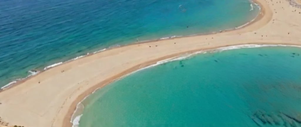 a beach with a sandy beach in prasonisi