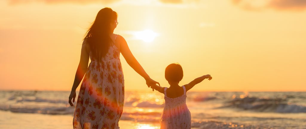 mother running with daughter on the beach
