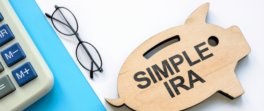 piggy bank a calculator and glasses for a simple ira