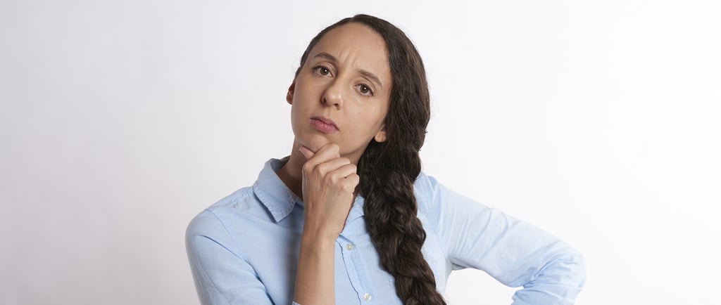 woman thinking thoroughly and wondering if gold ira is a scam