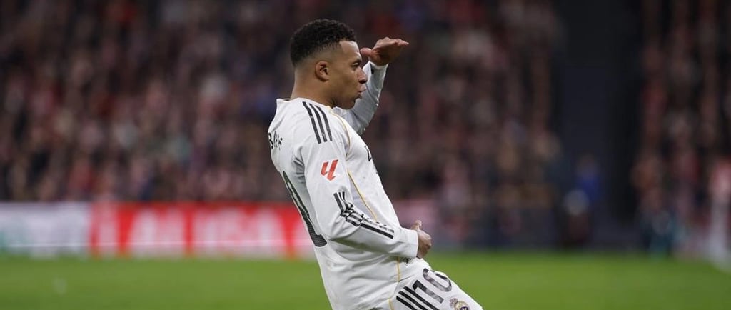 a man sitting on a soccer field with his foot in the air