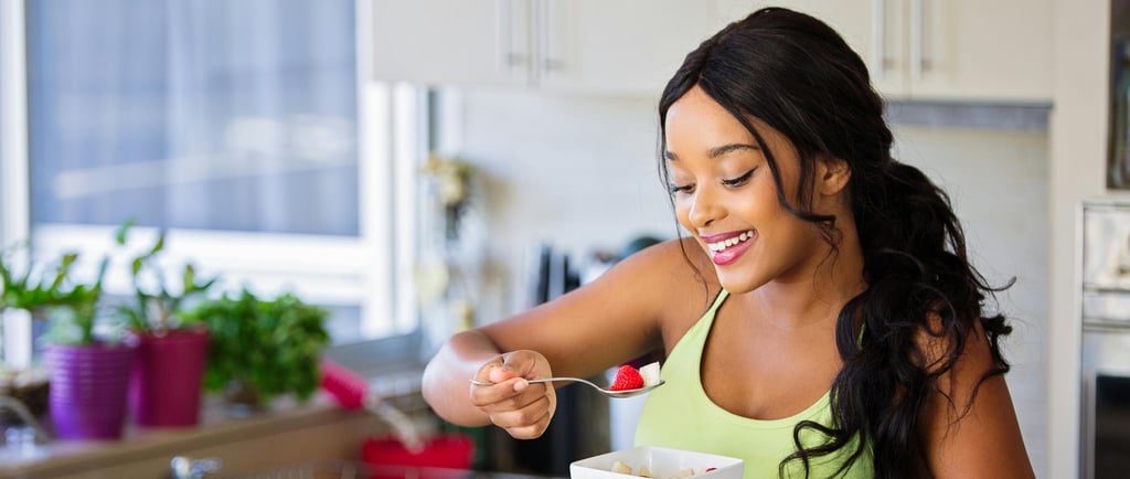 a woman in a green top and a bowl of food