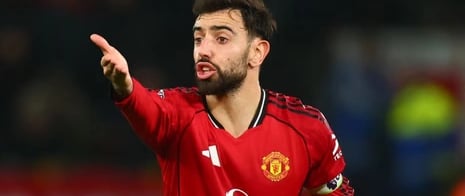 a man in a red jersey is pointing at something