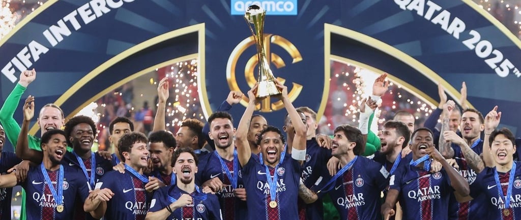 a group of men and women soccer players holding up a trophy