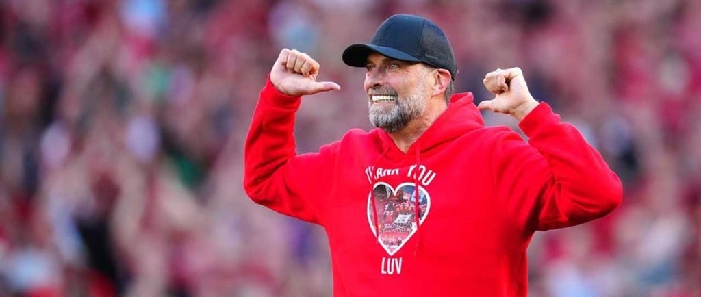 a man in a red hoodie and a baseball cap