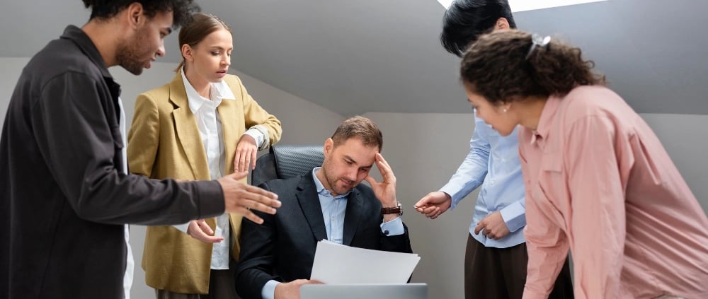 a group of people standing around a table